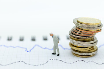 Miniature people: Businessman stand front of dashboard, display graphs, profit margins of ...