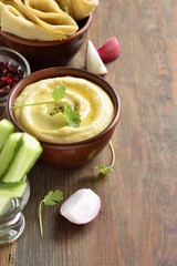 Healthy hummus dip with olive oil and pita bread and vegetables, vertical, copy space