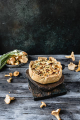 appetizing quiche with mushrooms on wooden table