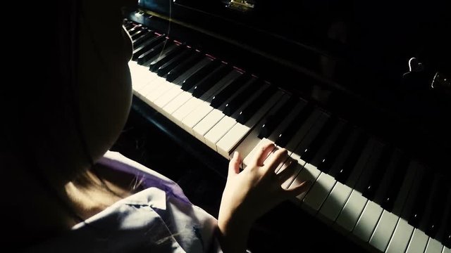 Asian little girl practicing piano