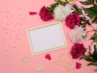 Frame of White and Pink Peony Flowers, Branches, Leaves and Petals With Space for Text on Pink Background. Home Decor. Flat Lay, Top View.