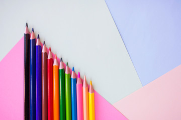 Colored pencils on the multi-colored paper background.