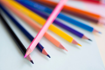 Colored pencils on the multi-colored paper background.