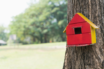Obraz na płótnie Canvas Creative handmade of wooden birdhouse on the tree in park, Painting colorful on wooden home of bird.