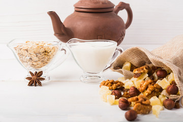 Oatmeal, milk and nuts with dry fruits; healthy breakfast concept