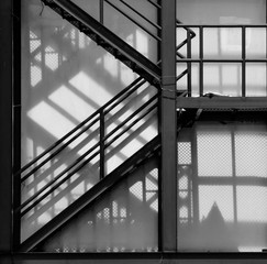 fire escape staircase with shadow - monochrome