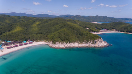 Drone aerial view from above on beautiful blue water bay on sunny day