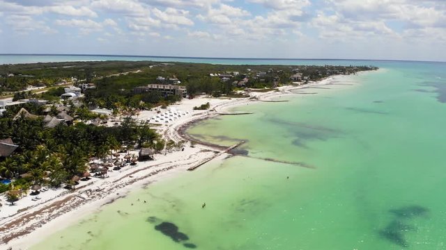 Aerial shot of Isla Holbox beachfront resorts on a sunny day, Mexico