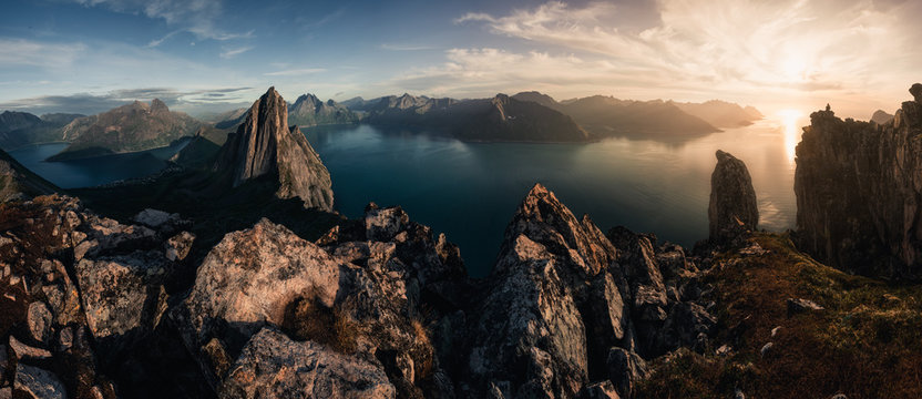 Mountainous panorma landscape view with huge fjords during golden sunset in Senja, Norway
