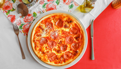 Italian traditional Pizza on the table in local restaurant, flat view
