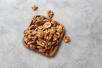 Walnut kernels on gray background.