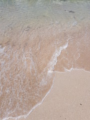 blue clear water and white sand on a sunny day
