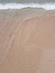 blue clear water and white sand on a sunny day