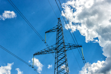 Power pylons and high-voltage lines against the background of the cloudy sky, power lines.