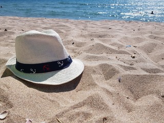 hat on the beach with white sand on a sunny day