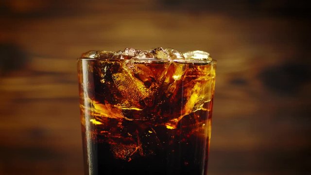 Cold cola with ice cubes