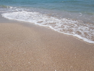 blue clear water and white sand on a sunny day