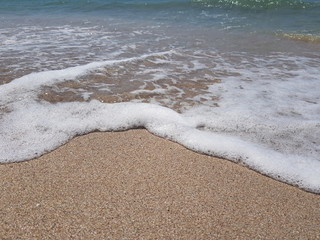 blue clear water and white sand on a sunny day