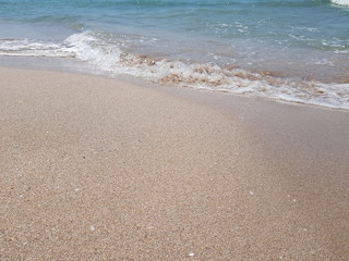 blue clear water and white sand on a sunny day