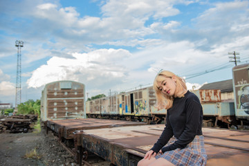 Portrait of young asian girl japanese style at the railway on sunset,Thailand people,Lifestyle of modern woman,She wear short skirt