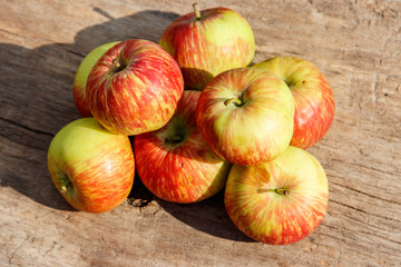 Fresh ripe apples on rustic wooden table