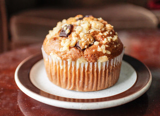 banana chocolate chip muffin on mahogany table