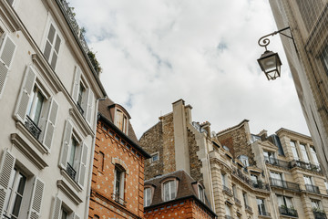 Paris residential buildings. Old Paris architecture, beautiful facade, typical french houses on sunny day. Famous travel destinations in Europe. City life, lifestyle and expensive real estate concept
