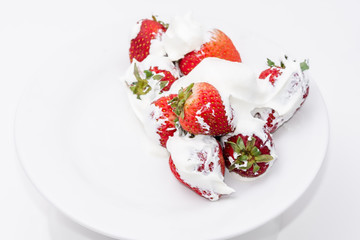 Fresh strawberries and cream on white plate with room for copy text