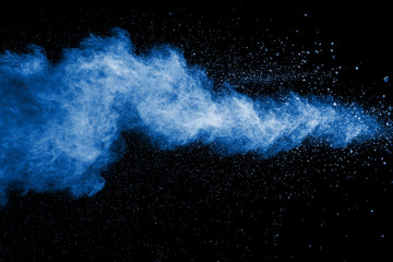 Splash of blue dust on black background.