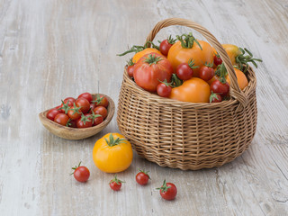 fresh tomatoes on a wooden table. 