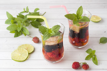 Cocktail with black currant, strawberry, mint and lime. Cooling summer drink.