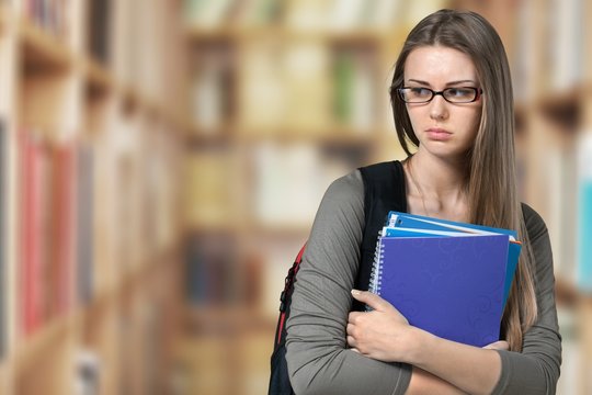 Young Student Girl with backpack and books
