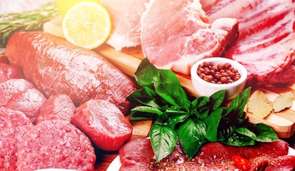 Close-up fresh raw white and red meat background with vegetables