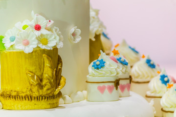 Cupcakes on tier at wedding reception./ Sweet beauty flower and topping pastel color on wedding cake decoration.