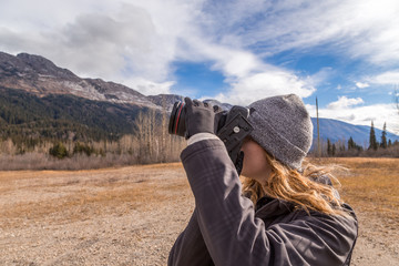 Girl taking photo of the Rocky Mountains