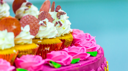Cupcakes on tier at wedding reception./ Sweet beauty flower and topping pastel color on wedding cake decoration.