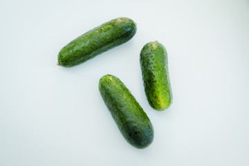 Small cucumbers on white background