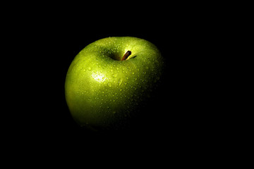 Green apple in a black background