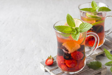 Cocktail with black currant, strawberry, mint and lime. Cooling summer drink.