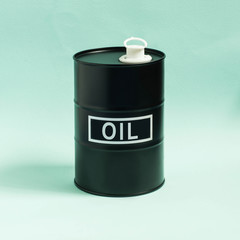Black barrel with oil on blue background