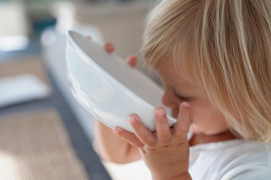 A Young Girl Eating Breakfast. 