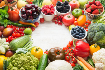Healthy summer fruits vegetables berries arranged in a circle frame, cherries peaches strawberries cabbage broccoli cauliflower squash tomatoes carrots beetroot, copy space, selective focus