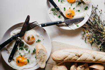 Rustic breakfast in the village. Breakfast sereved with eggs and home made bread on wooden background