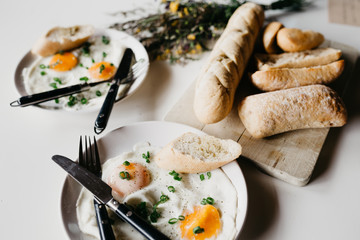 Rustic breakfast in the village. Breakfast sereved with eggs and home made bread on wooden background