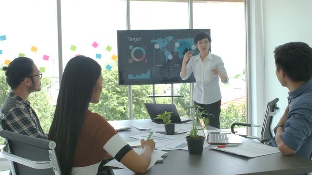 Business presentation. Attractive young business woman making presentation to her colleagues in the conference room.
