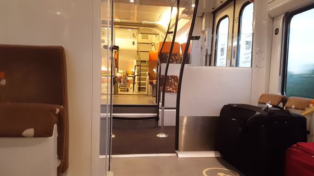 The early morning in a moving train, a view of empty seats and corridors