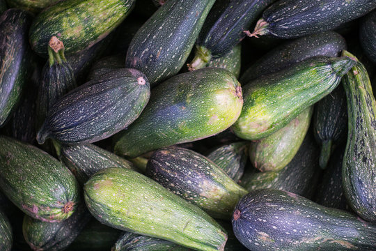 Green Fresh Zucchini ( Squash ) Stacked In A Heap Shot From Above. Close Up.