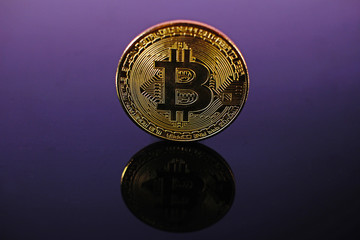 Bitcoin money crypto currency coin on reflective colorful background