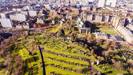 Aerial image of a low sun casting long shadows in Glasgow Necropolis. Victorian garden cemetery adjacent to Glasgow Cathedral.