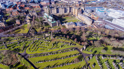 Aerial image of a low sun casting long shadows in Glasgow Necropolis. Victorian garden cemetery adjacent to Glasgow Cathedral.